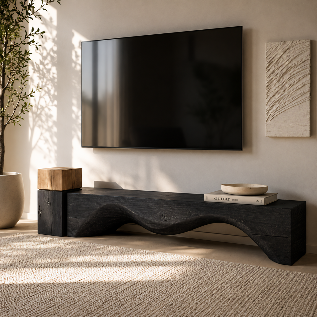 Modern living room with a black TV stand, television, and decorative items.