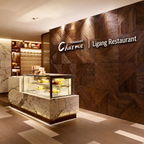 Restaurant interior with a decorative wall featuring 'Ligang Restaurant' and a display case.