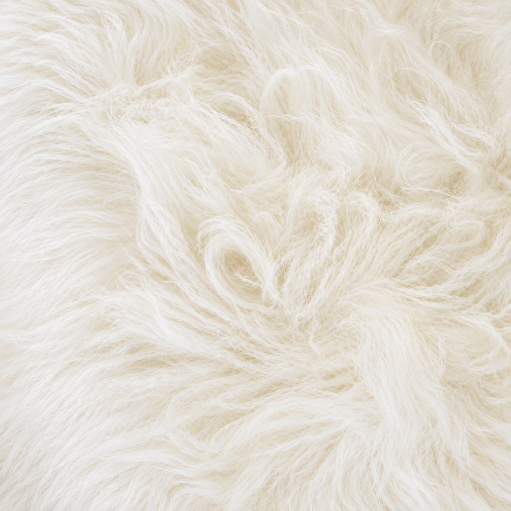 Close-up of fluffy faux fur fabric in a warm off-white or cream color, showing the soft texture and individual fibers.