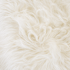 Close-up of fluffy faux fur fabric in a warm off-white or cream color, showing the soft texture and individual fibers.