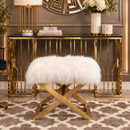 White faux fur ottoman with gold crossed legs styled in an elegant luxury interior