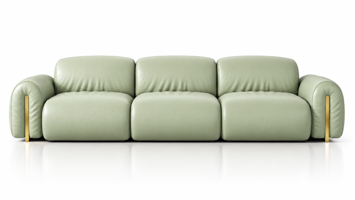A modern three-seater sofa upholstered in light sage green leather, featuring curved armrests and slim gold-toned metal legs, shown against a clean white background with a subtle reflection.