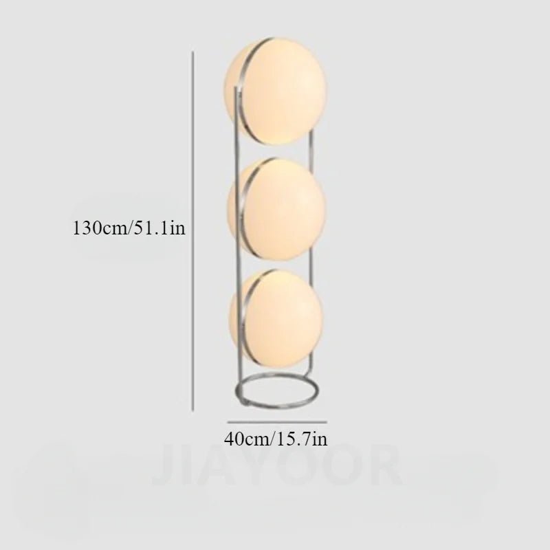 Decorative cylindrical lamp with three circular lights and measurements on a light gray background