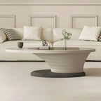 Modern living room with a beige sofa, coffee table, and decorative elements.