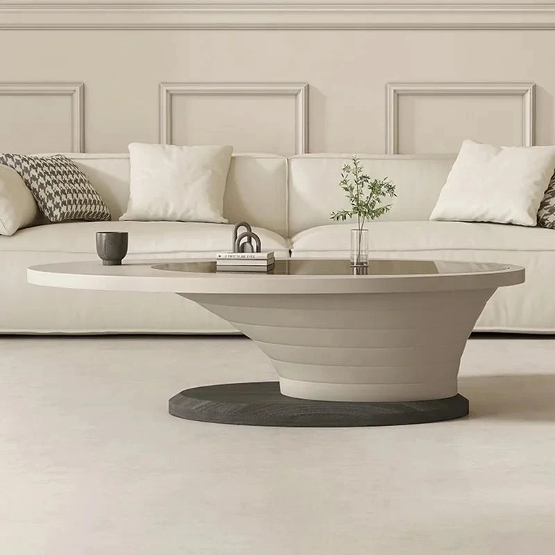 Modern living room with a beige sofa, coffee table, and decorative elements.