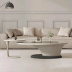 Modern living room with a beige sofa, coffee table, and decorative elements.