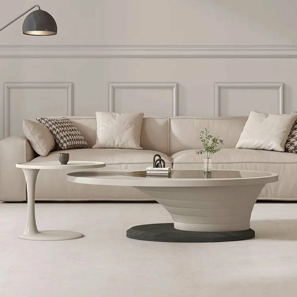Modern living room with a beige sofa, coffee table, and decorative elements.