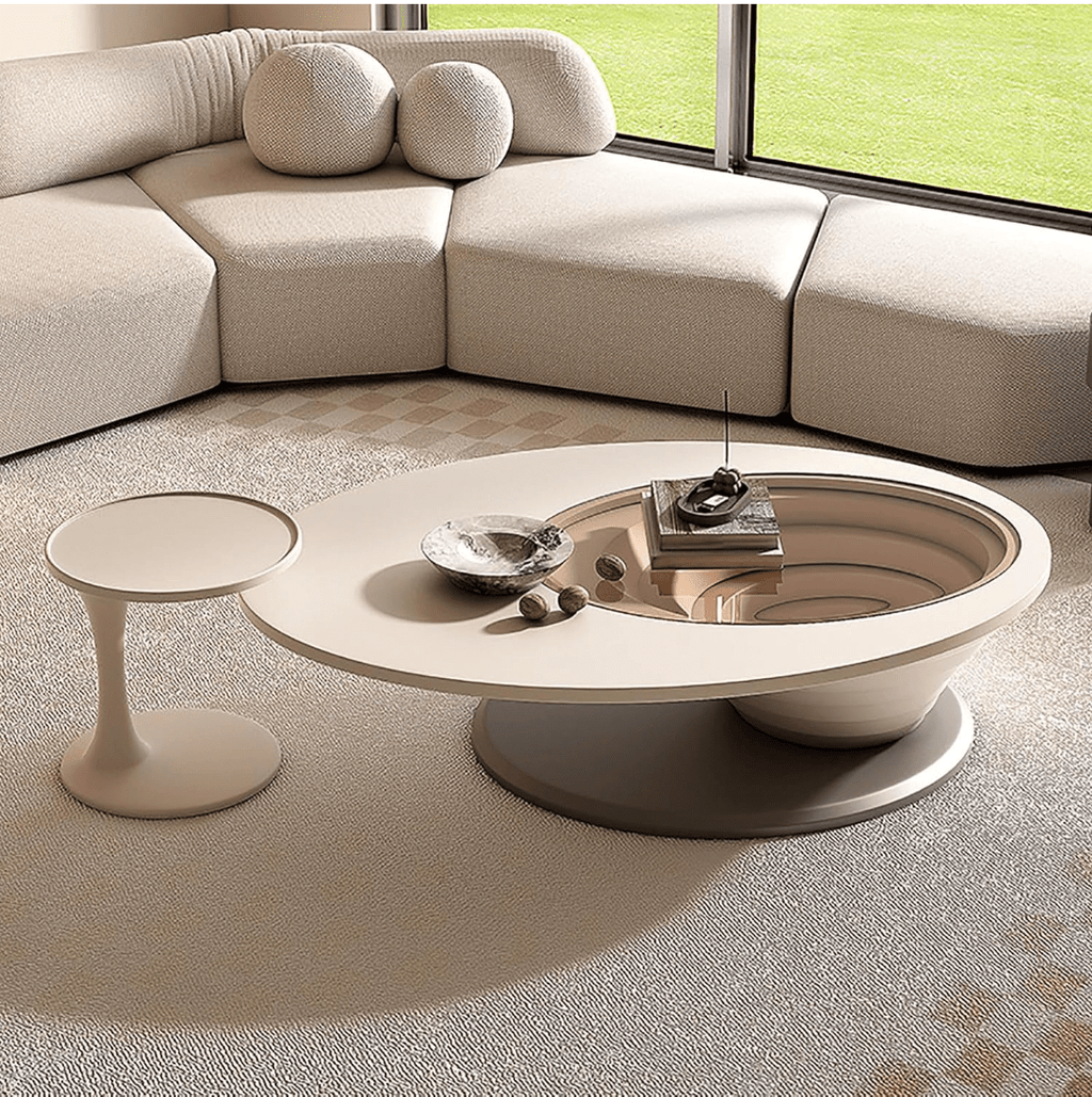 An oval-shaped luxury coffee table made of wood-based panels with a minimalist design, placed in a living room setting.