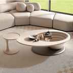 An oval-shaped luxury coffee table made of wood-based panels with a minimalist design, placed in a living room setting.