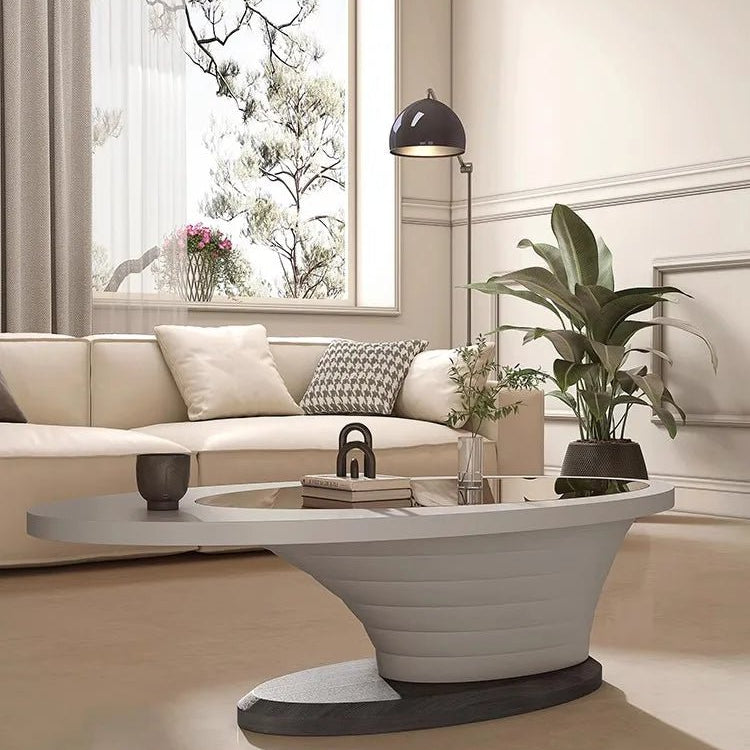 Modern living room with a beige sofa, coffee table, and decorative items.