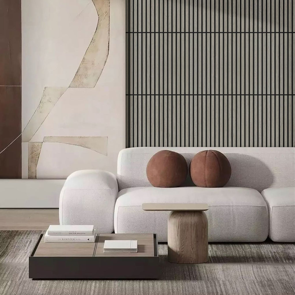Modern living room with a white sofa, wooden coffee table, and abstract wall art.
