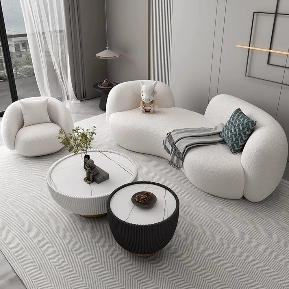 Modern living room with a white sofa, coffee table, and decorative items.