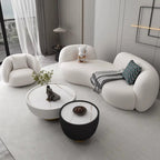 Modern living room with a white sofa, coffee table, and decorative items.