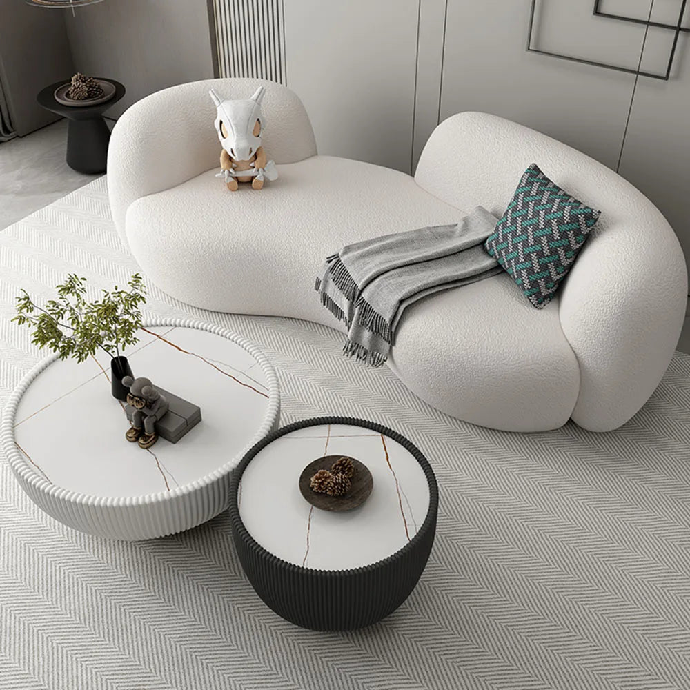Modern living room with a white cloud-shaped sofa and decorative items.