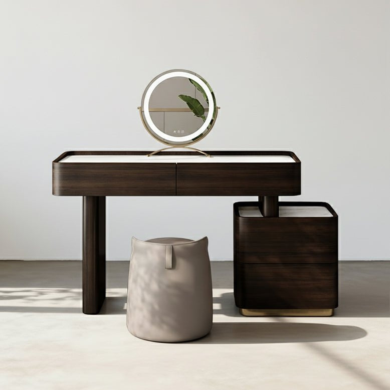 Modern dark wood console table with a round mirror and a small stool on a neutral background