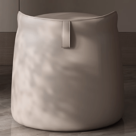Beige pouf with a metallic handle on a wooden floor.
