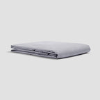 Folded light gray sheet on a white background