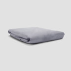 Folded gray fabric on a light gray background