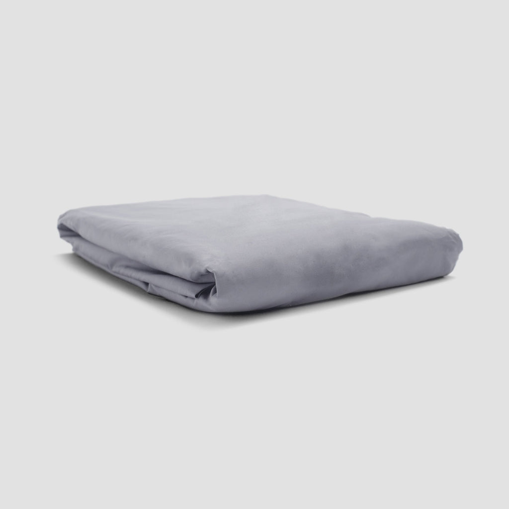Folded gray blanket on a light gray background