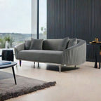 Gray sofa in a modern living room with large windows and decorative elements.