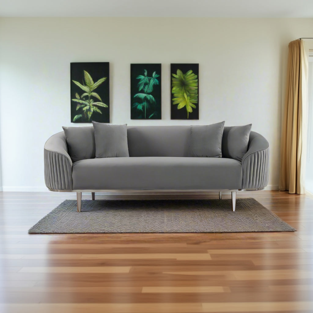 Gray sofa in a room with wooden flooring and wall art