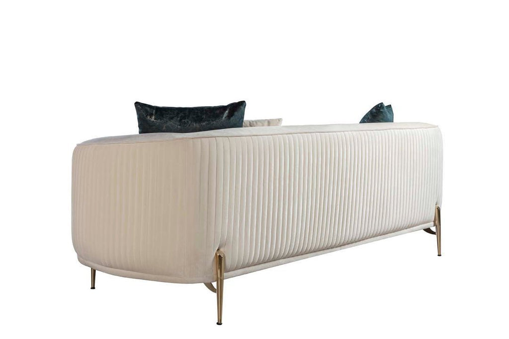 Beige sofa with black and blue cushions on a white background