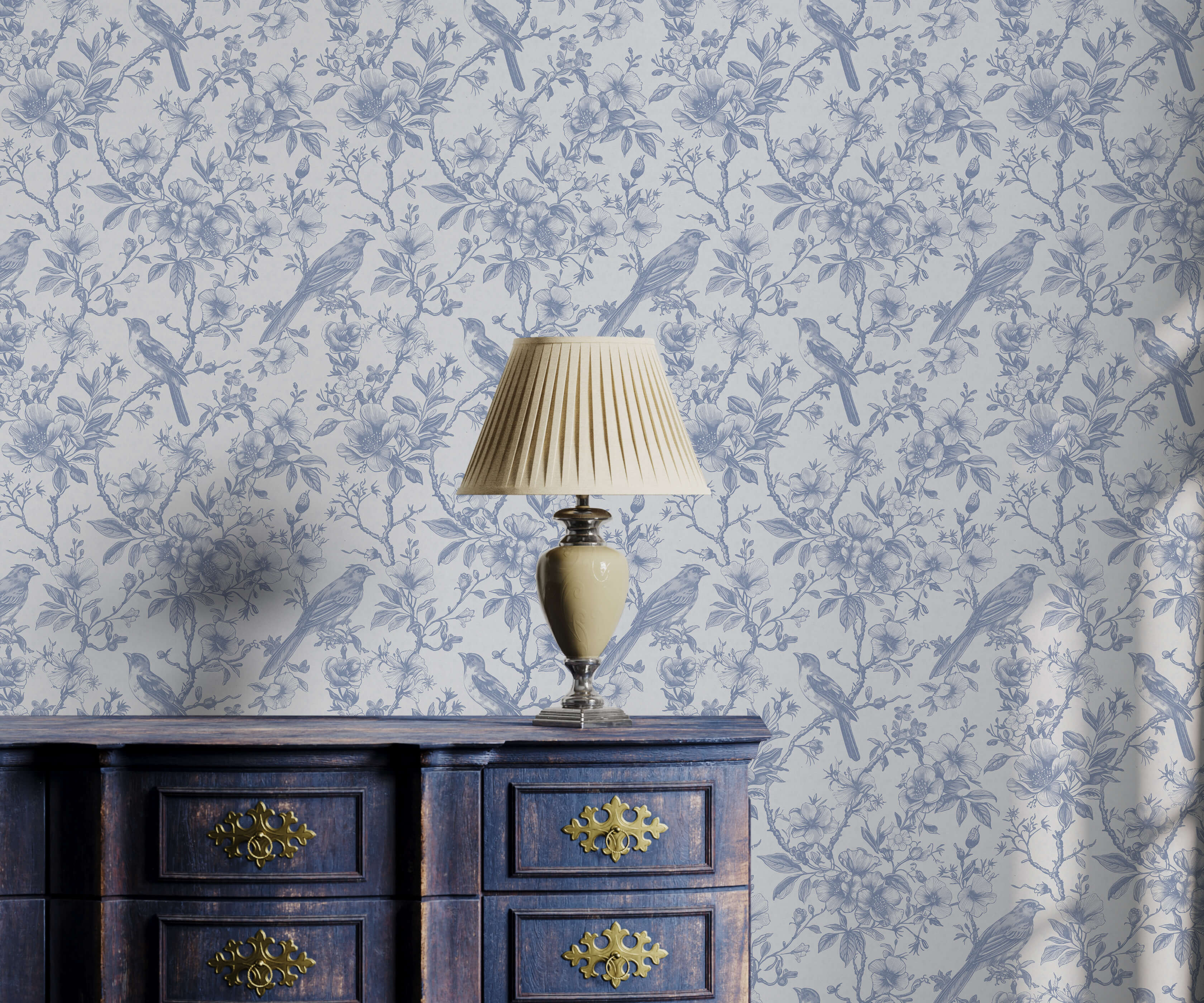 Decorative lamp on a wooden cabinet with floral wallpaper in the background