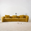 Mustard yellow sofa in a minimalistic room with a white textured wall.
