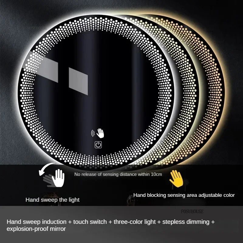 A round LED bathroom mirror with a silver aluminum frame, featuring a digital display at the bottom and illuminated with multicolored lights, mounted on a wall above a white sink.