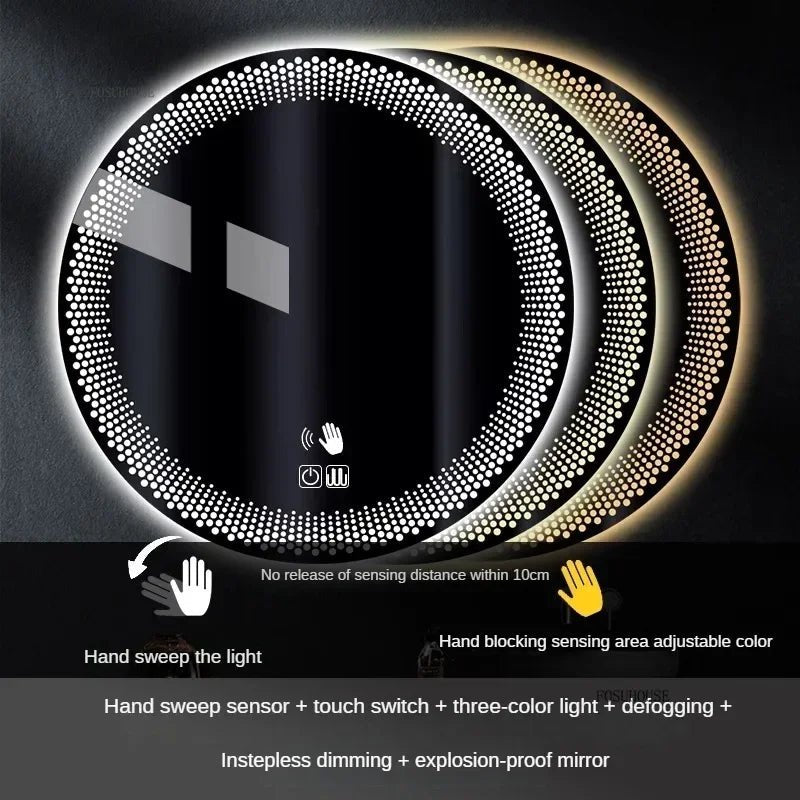 A round LED bathroom mirror with a silver aluminum frame, featuring a digital display at the bottom and illuminated with multicolored lights, mounted on a wall above a white sink.