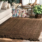 Brown textured rug in a living room setting with a couch and decorative pillows.
