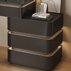 Modern black nightstand with gold accents on a wooden floor.