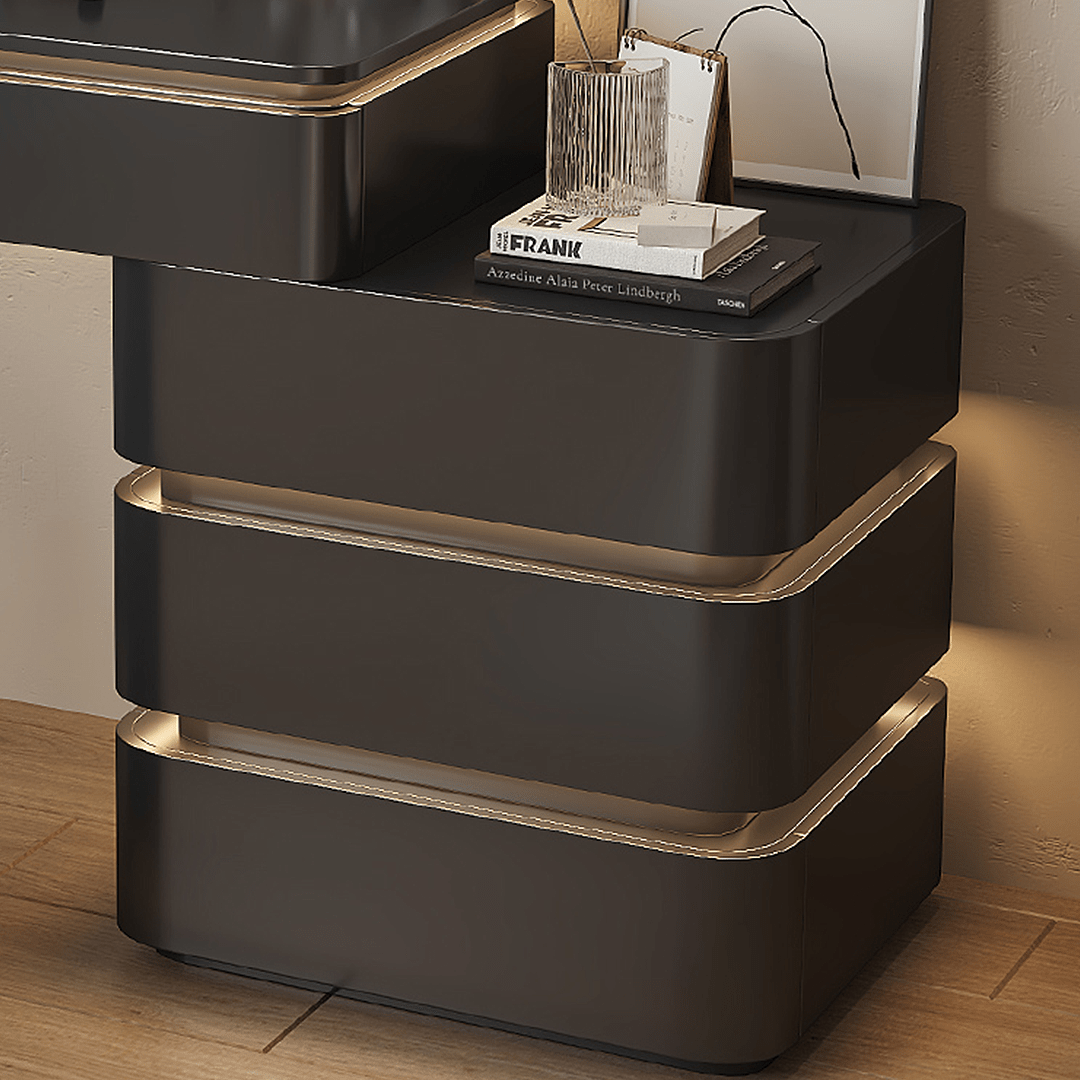 Modern black nightstand with gold accents on a wooden floor.