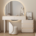 Modern white vanity with round mirror and chair in a room.