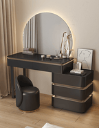 Modern vanity table with round mirror and decorative items in a bedroom setting
