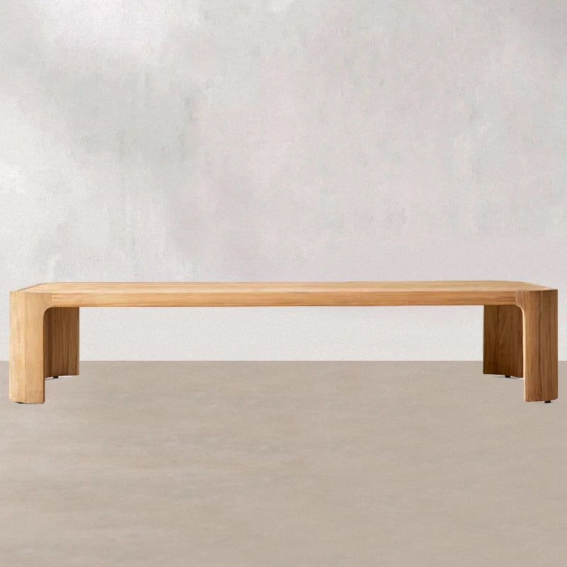 Wooden bench against a plain white wall