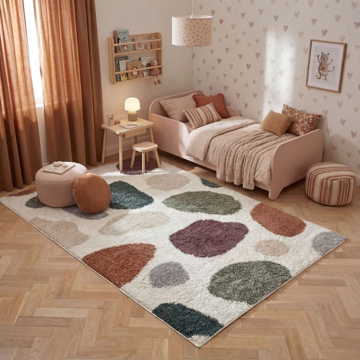 Children's bedroom with a patterned rug, pink bed, and decorative pillows.