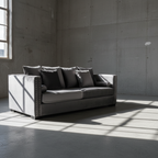 Gray sofa in a room with concrete walls and floor