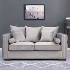 Gray sofa with decorative pillows in a room with a framed picture on the wall.