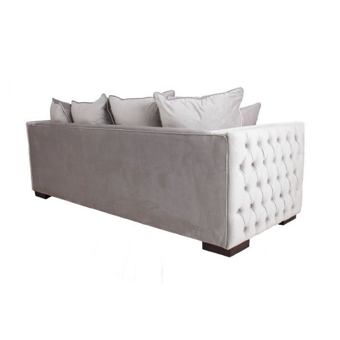 Gray sofa with tufted white armrests on a white background