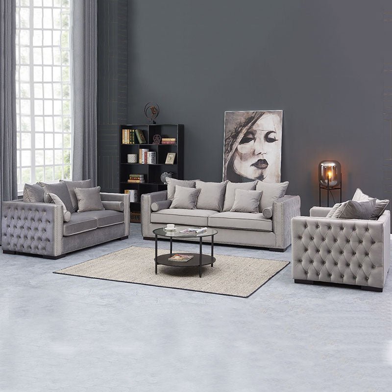 Modern living room with gray sofa, armchairs, and coffee table.
