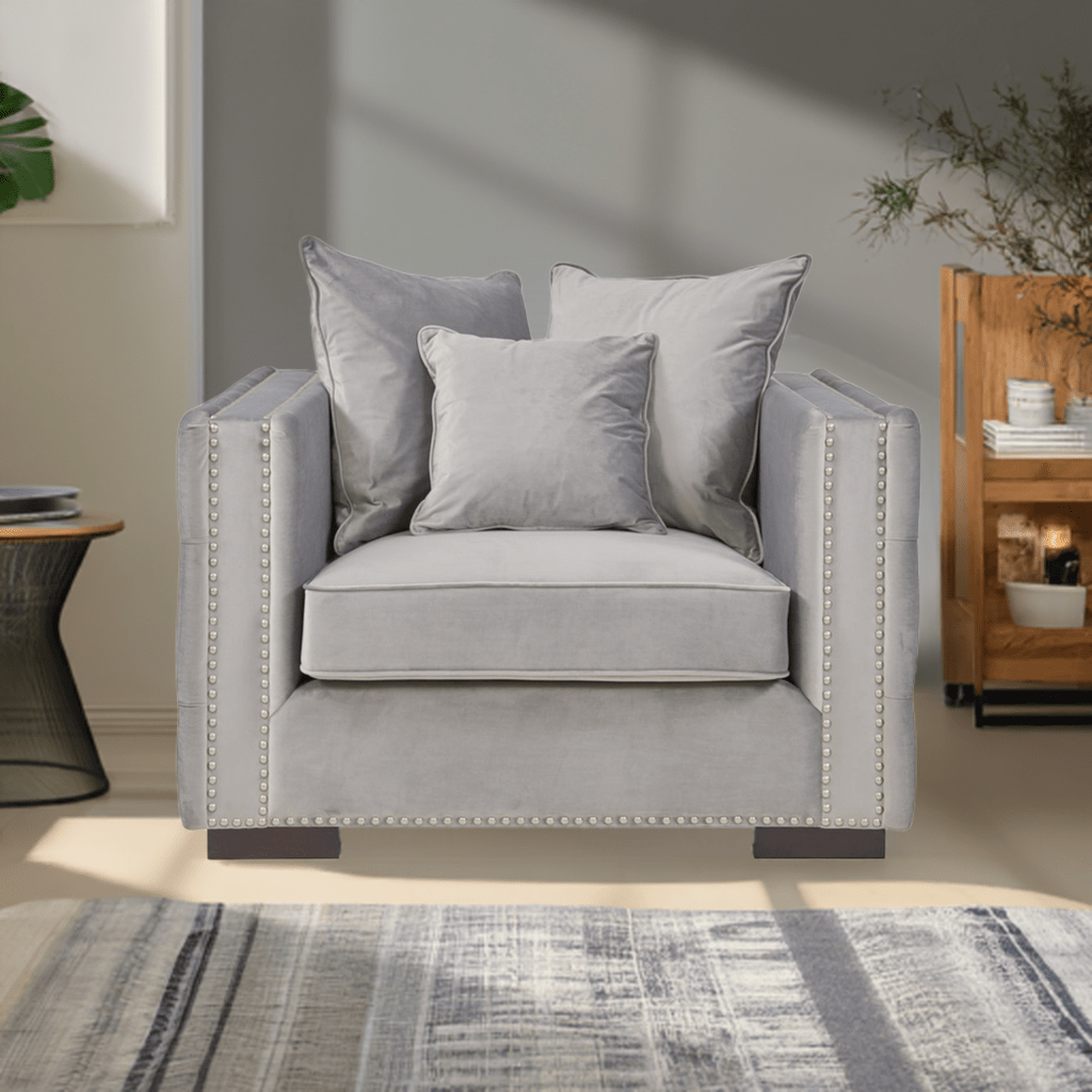Gray armchair with decorative pillows in a living room setting