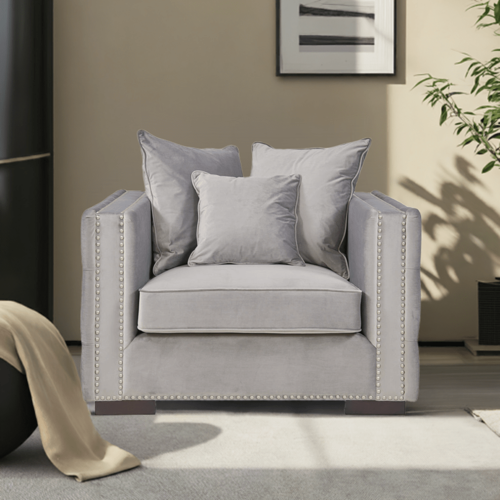 Gray armchair with decorative pillows in a living room setting