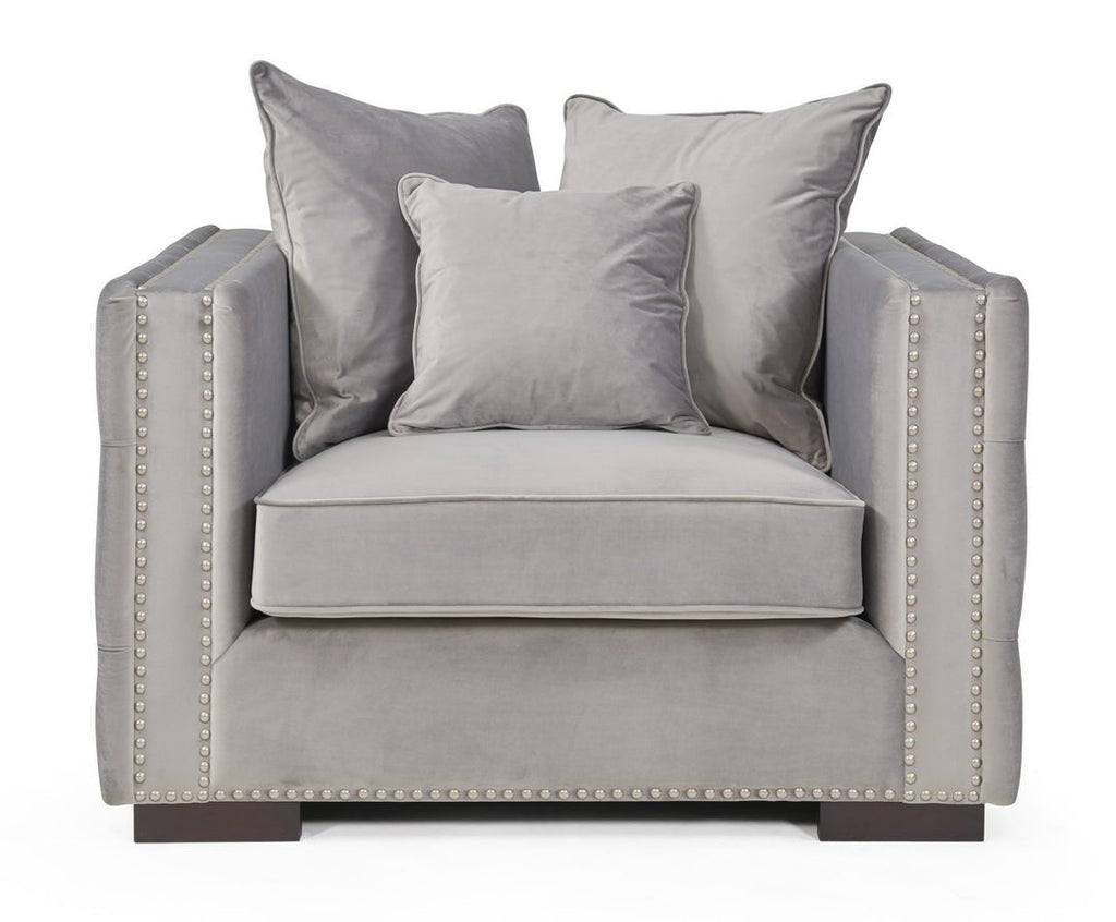 Gray armchair with decorative pillows on a white background