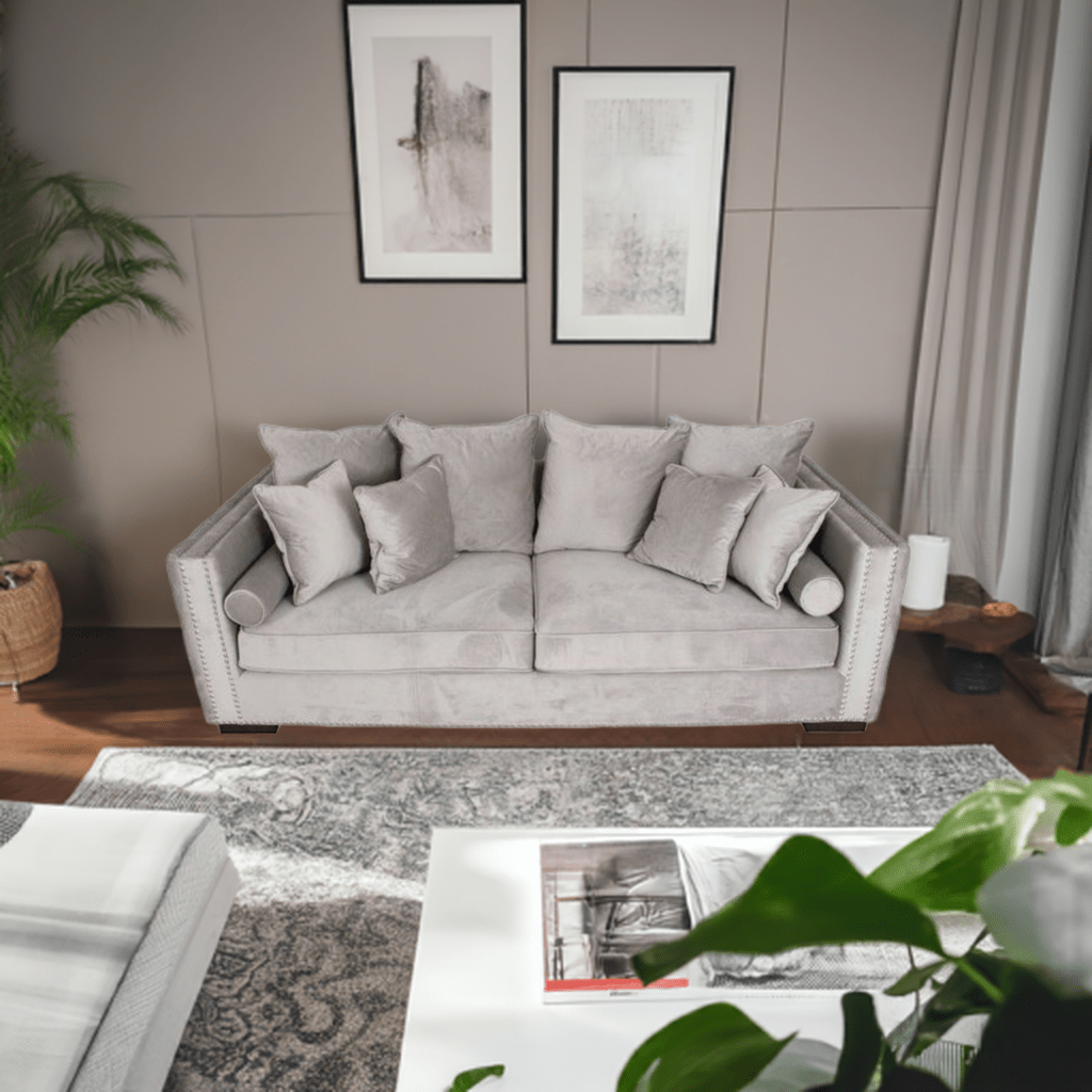 Gray sofa in a living room with framed art on the wall and a coffee table.