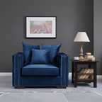 Navy blue armchair with decorative pillows in a living room setting.