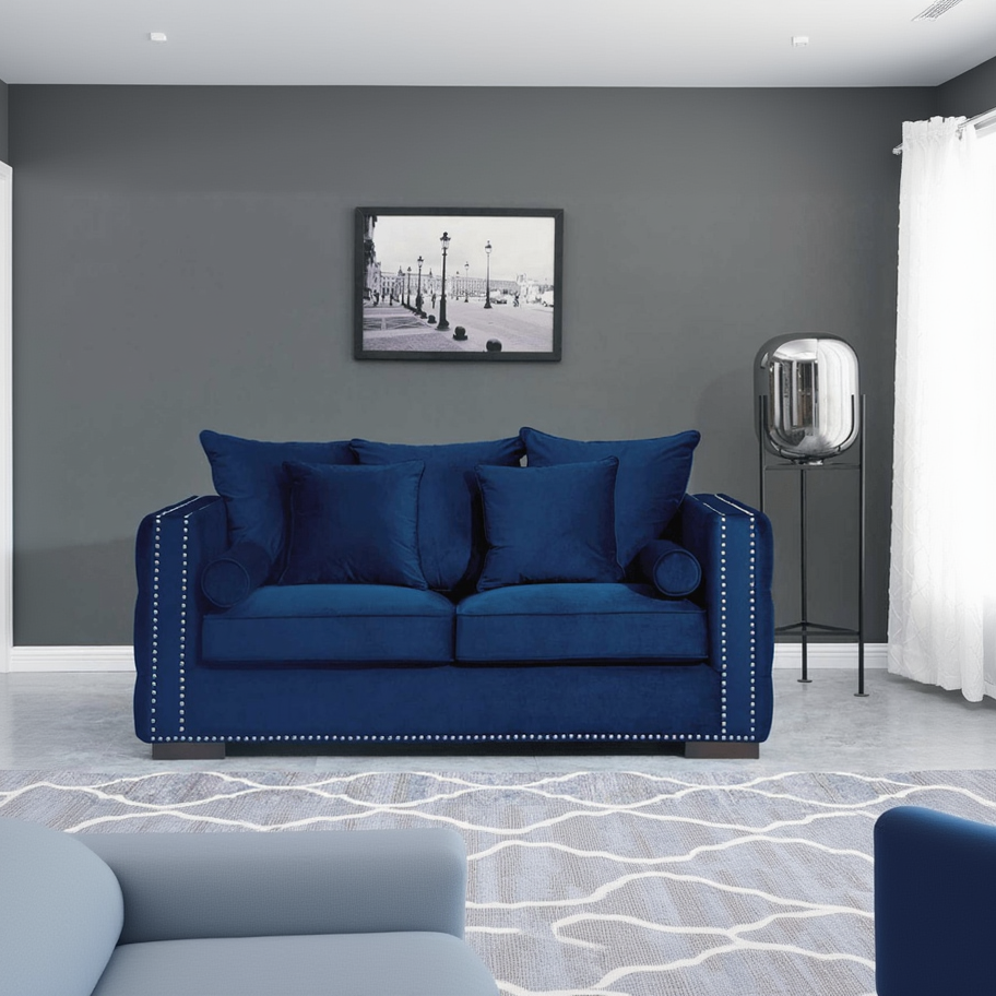 Blue sofa with decorative pillows in a living room setting.