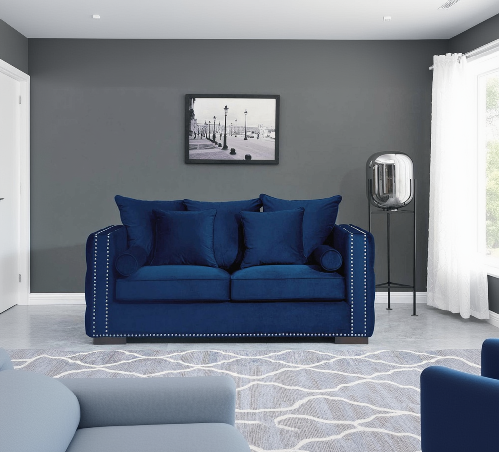 Blue sofa with decorative pillows in a living room setting.