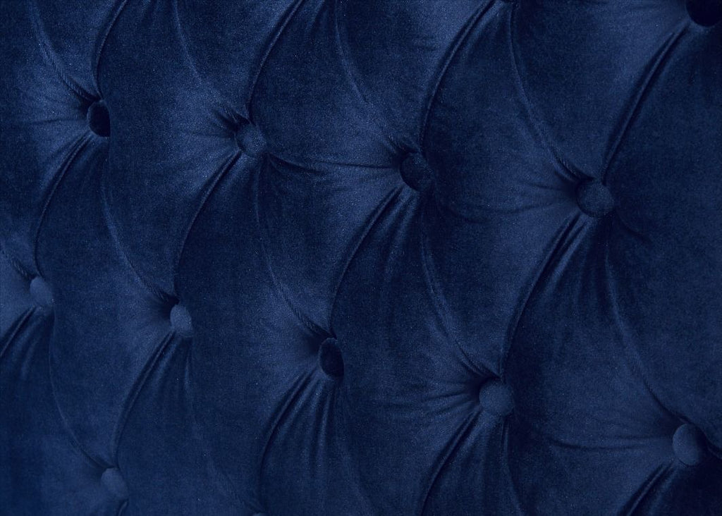 Close-up of a tufted blue velvet headboard