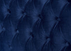 Close-up of a tufted blue velvet headboard